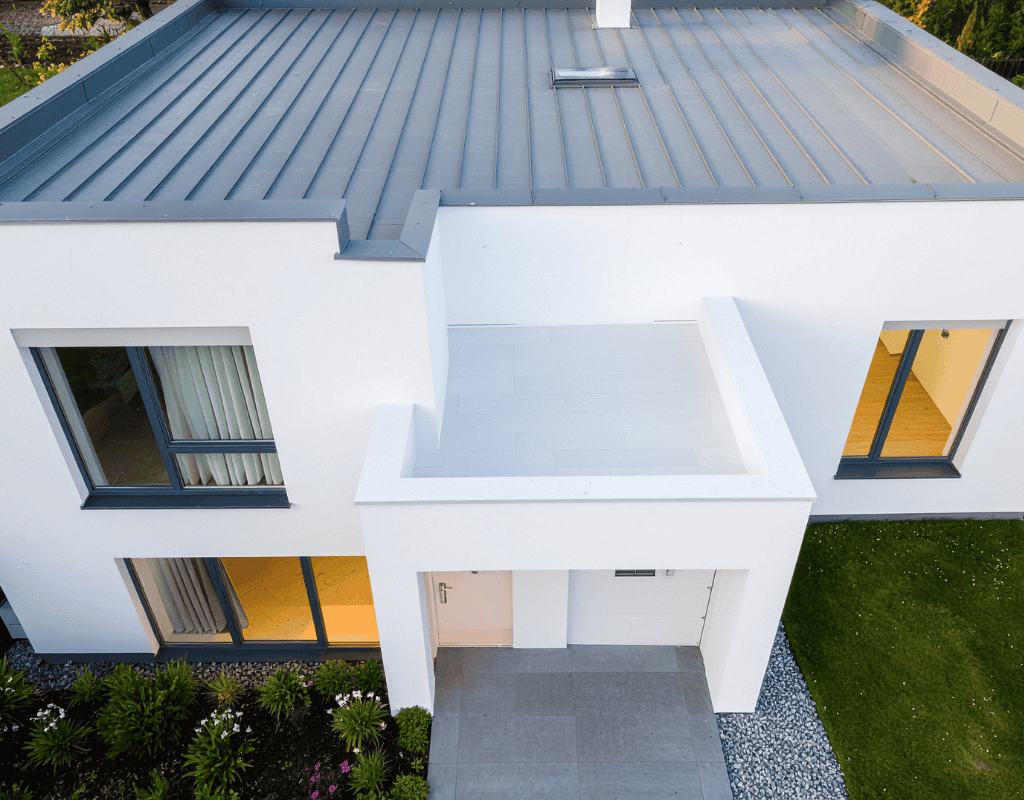 Modern commercial building with flat metal roofing system installed by roofing contractors