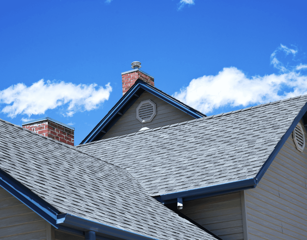 Close view of asphalt shingle residential roof with chimney on suburban Chicagoland home