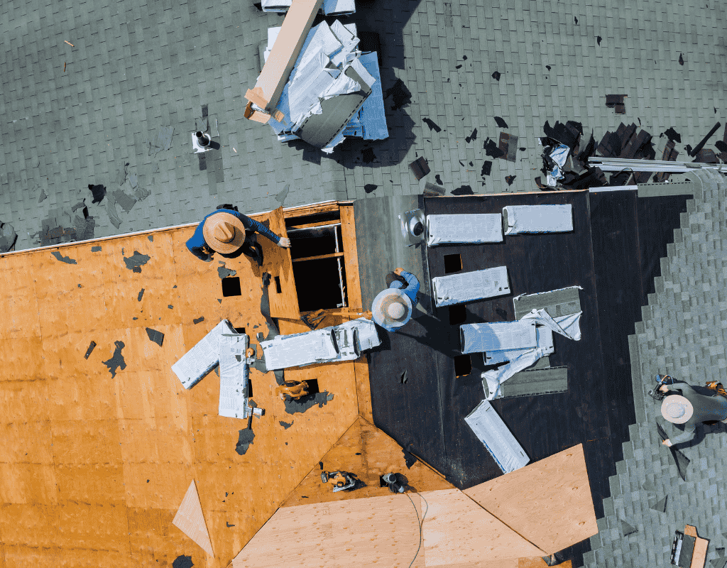 Aerial view of roofing crew replacing damaged roof decking and installing new roofing system in Chicagoland Illinois