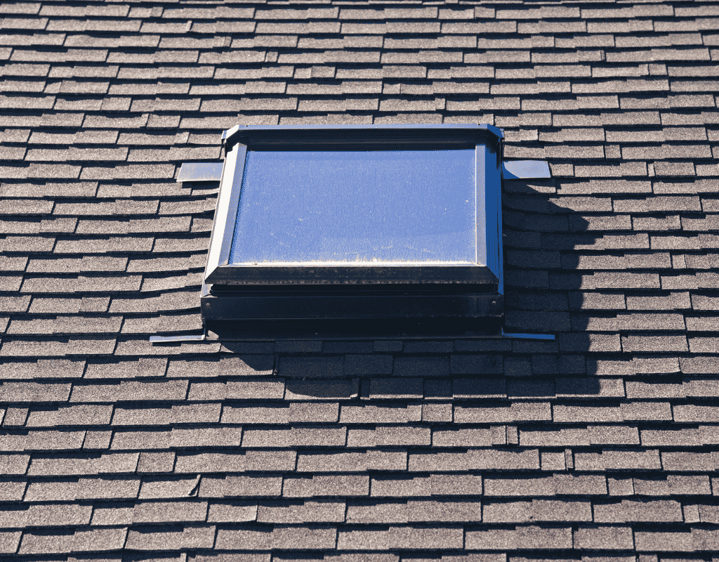 Rectangular skylight installed on asphalt shingle roof during skylight replacement project
