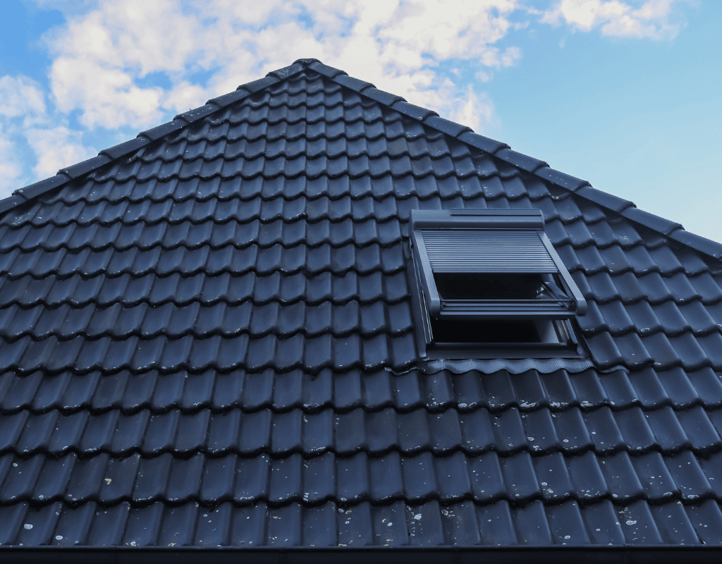 Modern roof skylight installed on dark tile residential roof allowing natural light inside