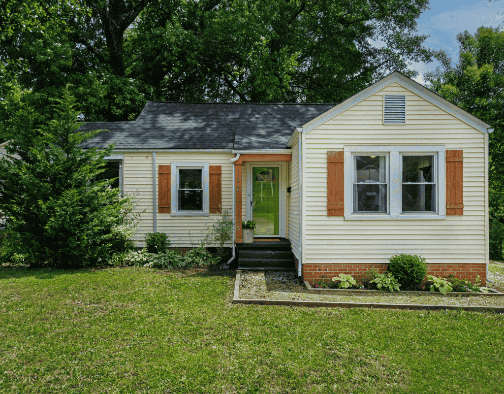 Small residential home with newly installed vinyl siding and asphalt shingle roof