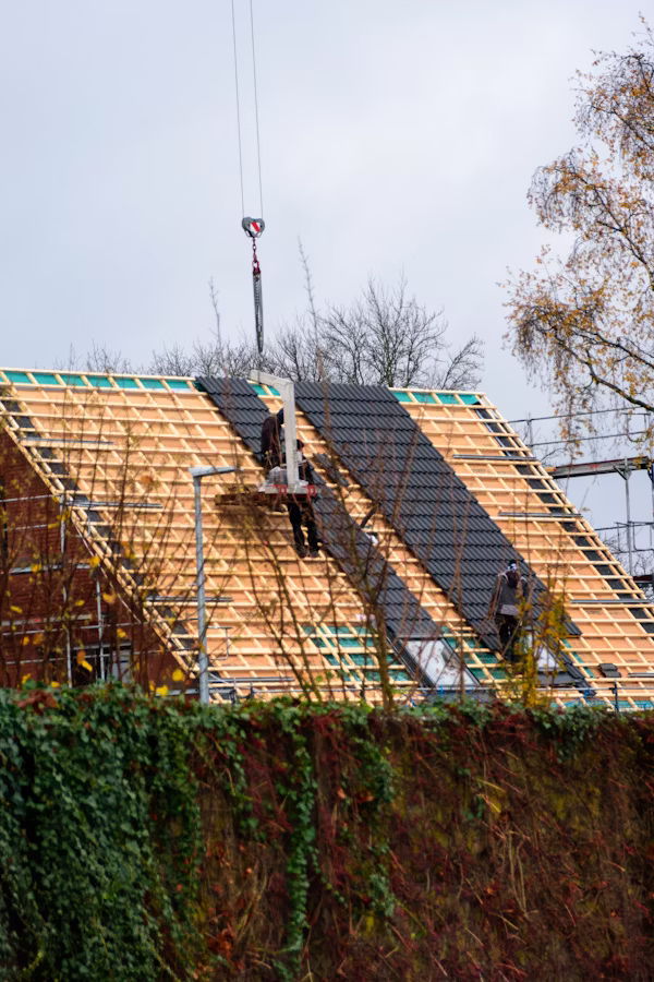 Inspector examining roof flashing and shingles on Chicagoland home after seasonal weather exposure
