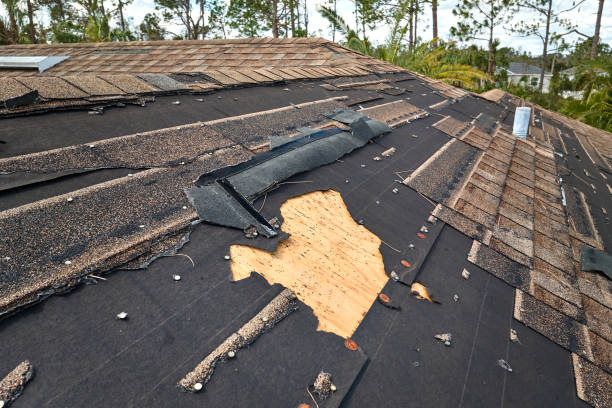 Technician performing roof repair on a Highland Park - IL home while checking flashing around a vent